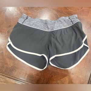 Lululemon Black Lined Running Shorts with gray waistband and light pink piping